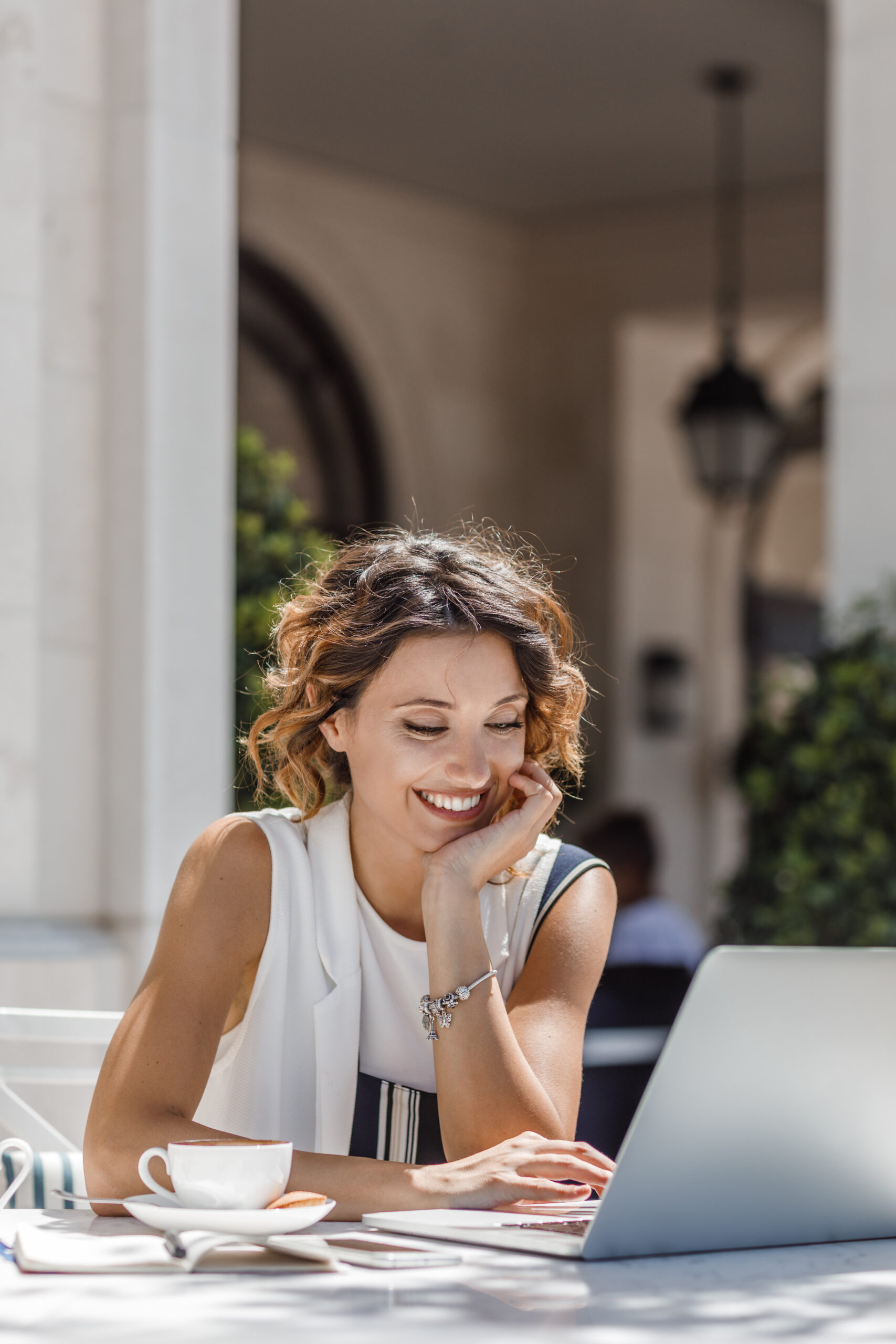 Professional woman using a laptop to manage hosting services